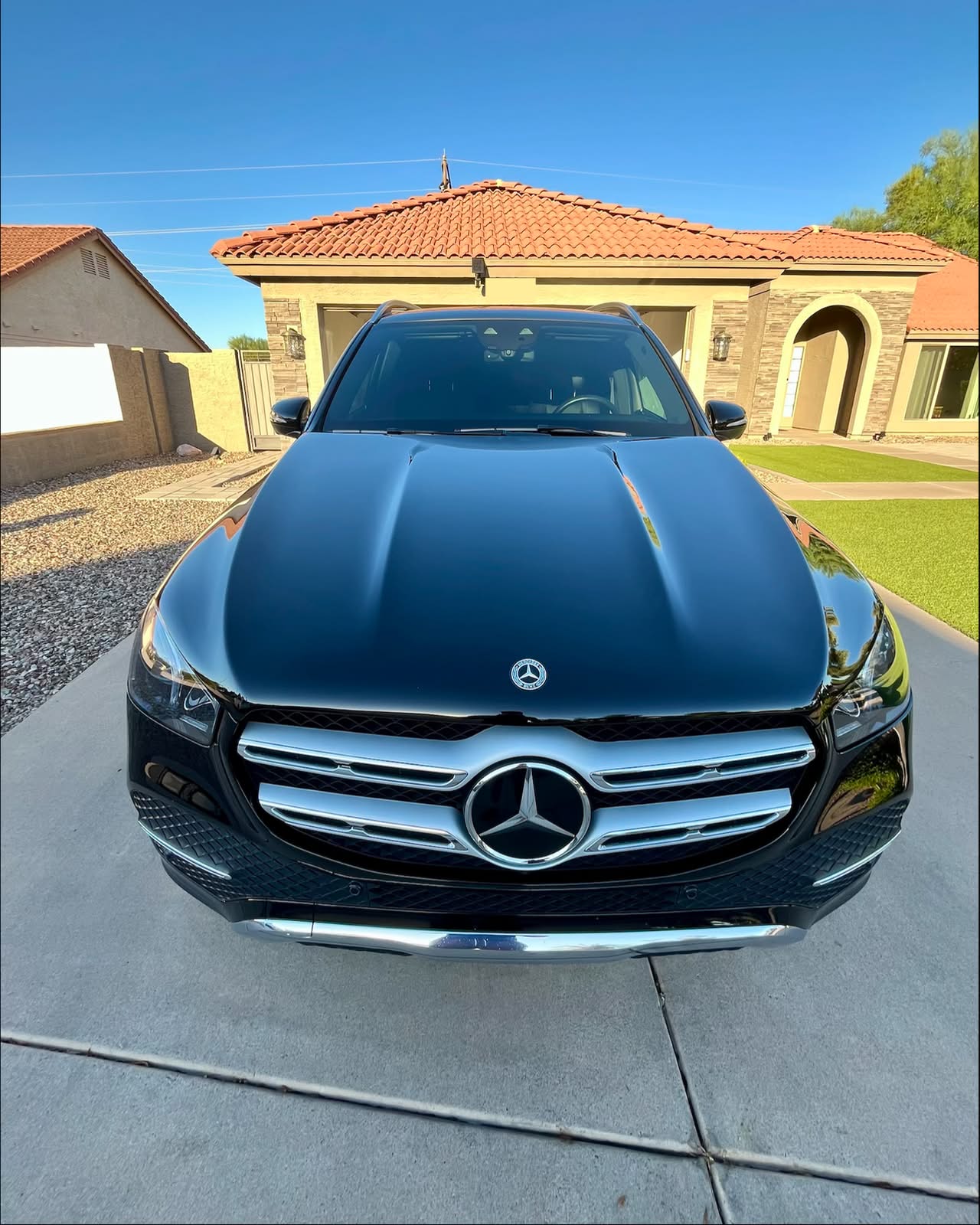 Black Mercedes GLE with a mirror-gloss finish parked in a driveway
